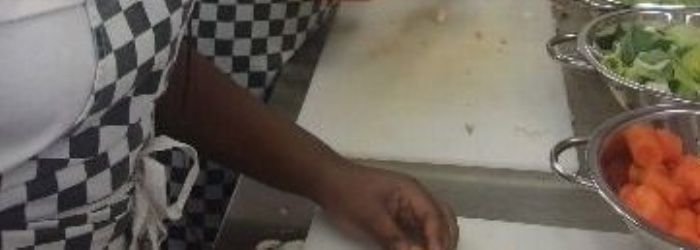 All Saints Students chopping veg in the kitchen